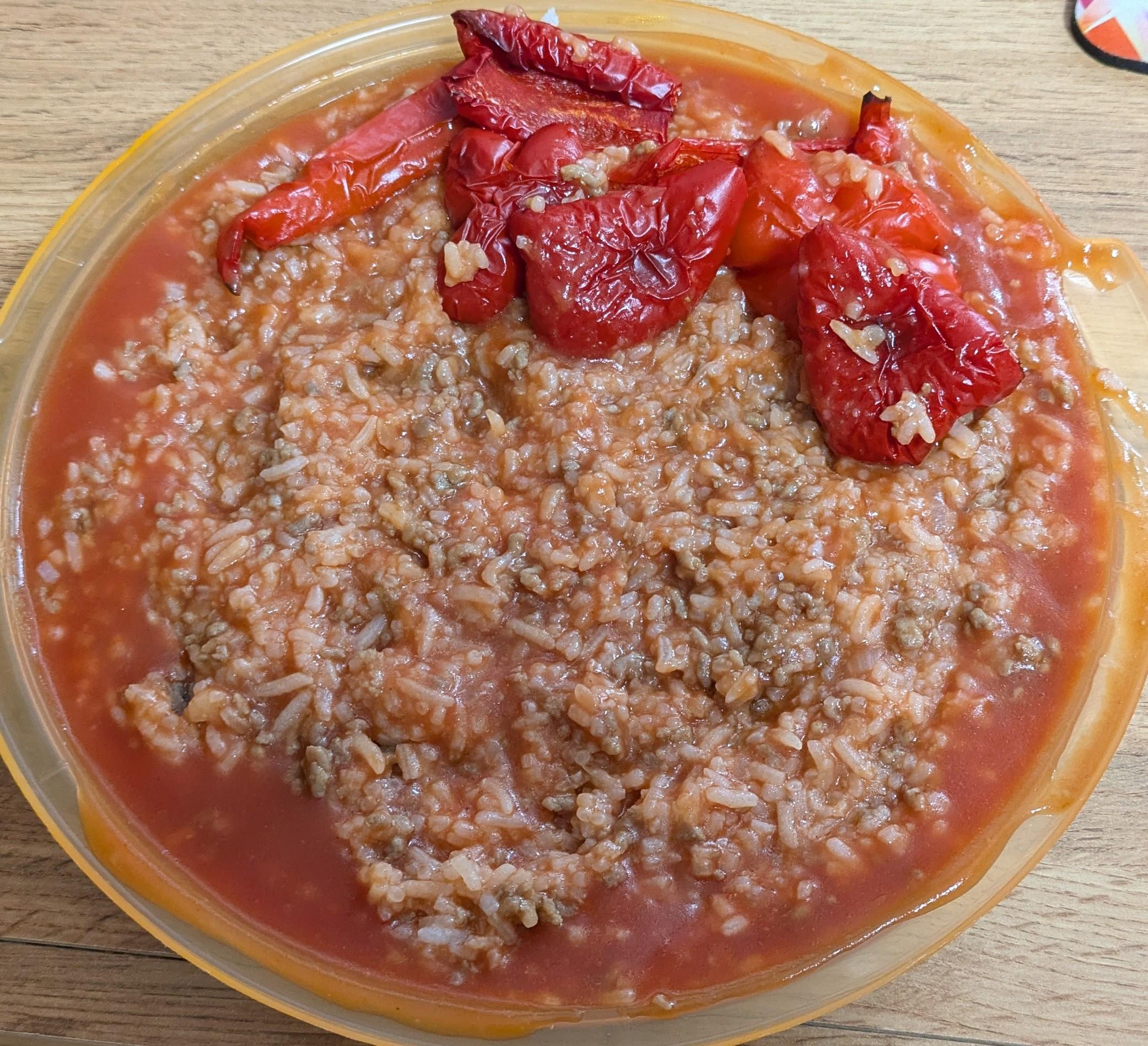Rice mixed with minced meat in a tomato souce with baked red pepper